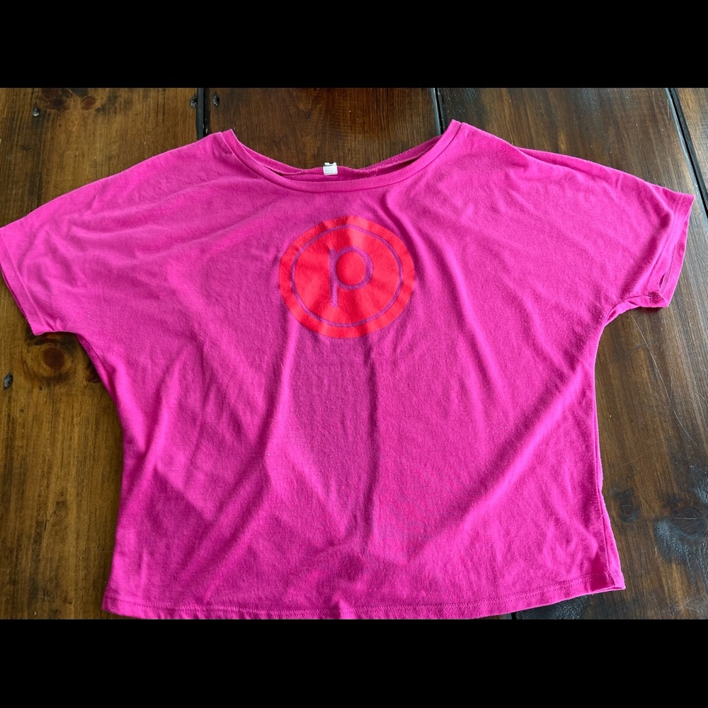 Pink, short waisted, open back PURE BARRE tee.